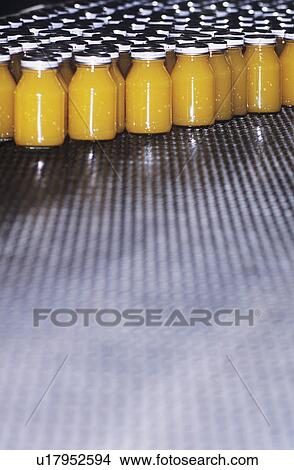 Picture - Jars of orange liquid. Fotosearch