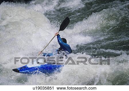 Kayaker paddling through white water Rapids View Large Photo Image Stock Image - Kayaker paddling through white water Rapids. Fotosearch