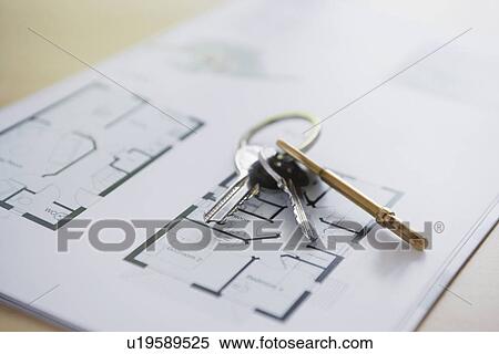 Stock Photography - Key ring with three keys lying on architectural blueprint close-up. Fotosearch