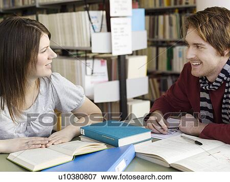 Male and female student talking in library View Large Photo Image Stock Photo - Male and female student talking in library. Fotosearch