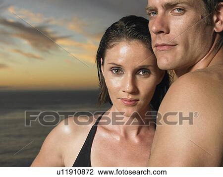 Man and woman by ocean at sunset close-up View Large Photo Image Stock Image - Man and woman by ocean at sunset close-up. Fotosearch