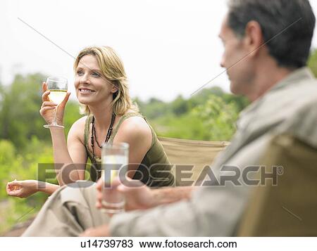 Man and woman sitting drinking selective focus View Large Photo Image Stock Image - Man and woman sitting drinking selective focus. Fotosearch