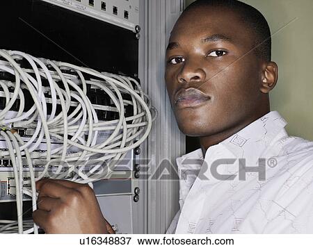 Man connecting network cables. View Large Photo Image Stock Photo - Man connecting network cables.. Fotosearch
