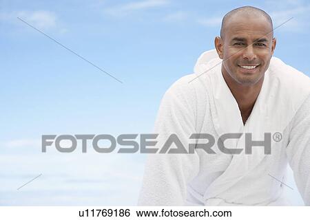 Stock Photograph - Man in bathrobe smiling half length. Fotosearch