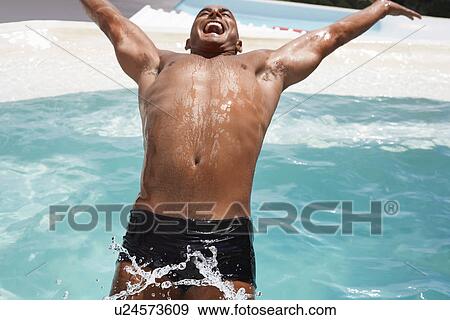 Man in diving backwards into swimming pool smiling half length View Large Photo Image Stock Photo - Man in diving backwards into swimming pool smiling half length. Fotosearch