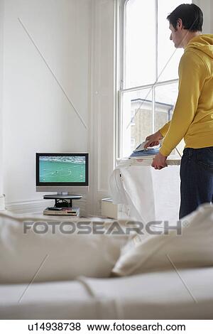 Man ironing and watching television View Large Photo Image Stock Photo - Man ironing and watching television. Fotosearch