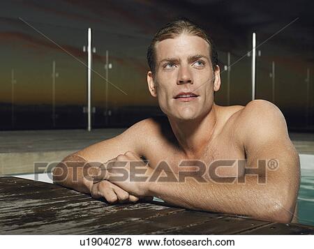 Man leaning on edge of outdoor pool at dusk View Large Photo Image Stock Photo - Man leaning on edge of outdoor pool at dusk. Fotosearch