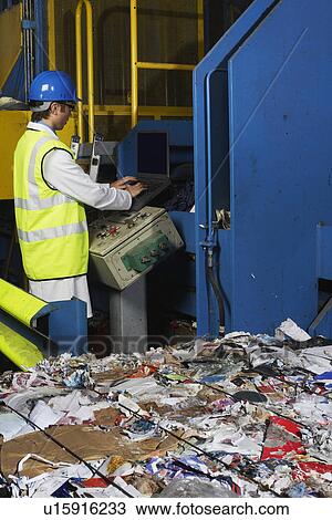 Man operating conveyor belt in recycling factory side view View Large Photo Image Stock Image - Man operating conveyor belt in recycling factory side view. Fotosearch