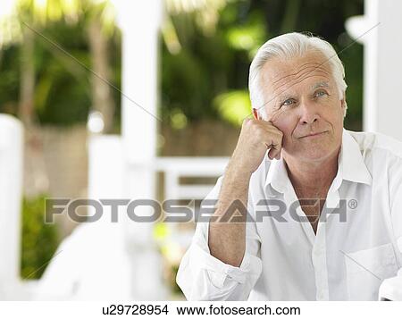 Picture - Man sitting on verandah portrait. Fotosearch