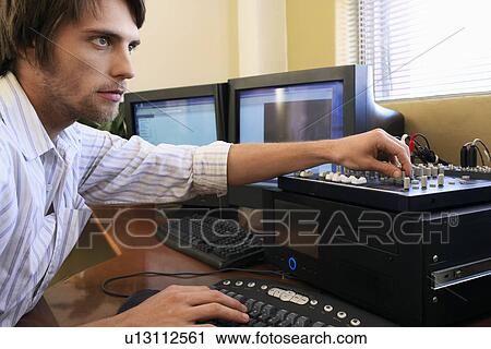 Man using computer keyboard and adjusting knob on mixer. View Large Photo Image Stock Image - Man using computer keyboard and adjusting knob on mixer.. Fotosearch