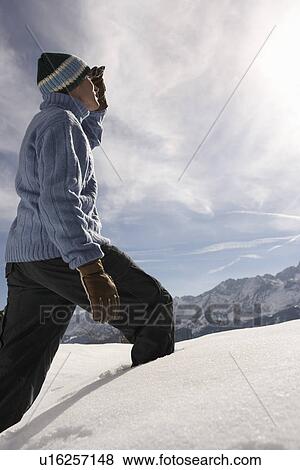 Man walking in fresh snow side view View Large Photo Image Stock Photo - Man walking in fresh snow side view. Fotosearch