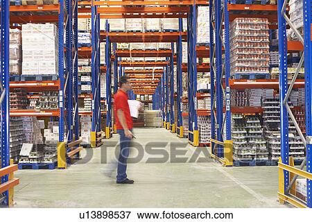 Man Walking Through Warehouse side view View Large Photo Image Stock Photo - Man Walking Through Warehouse side view. Fotosearch