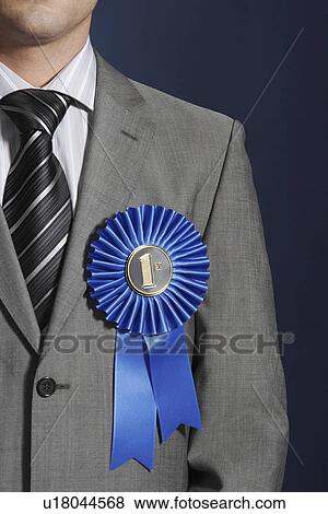 Man wearing blue ribbon on lapel against dark background mid section View Large Photo Image Stock Photo - Man wearing blue ribbon on lapel against dark background mid section. Fotosearch