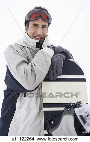 Man wearing ski goggles holding snowboard portrait View Large Photo Image Picture - Man wearing ski goggles holding snowboard portrait. Fotosearch