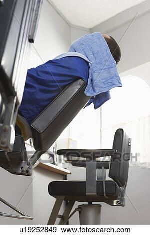 Stock Photo - Man with towel over head at barbers. Fotosearch