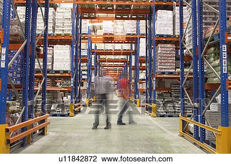 Stock Image - Men Walking in Warehouse. Fotosearch