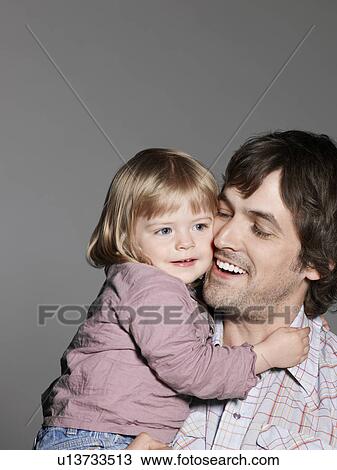 Stock Image - Mid adult father with baby daughter (1-2 years). Fotosearch