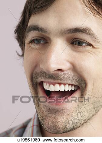 Stock Image - Mid adult man laughing close-up. Fotosearch