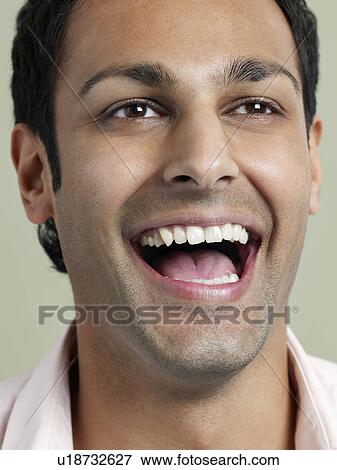 Mid adult man laughing close-up View Large Photo Image Stock Photo - Mid adult man laughing close-up. Fotosearch