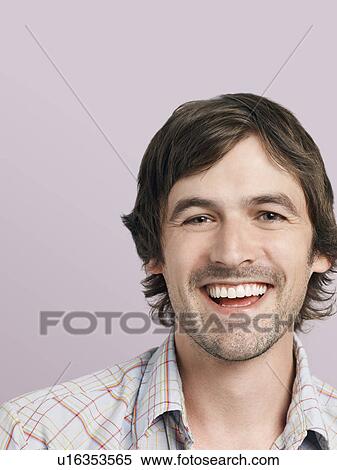 Stock Photography - Mid adult man laughing close-up. Fotosearch