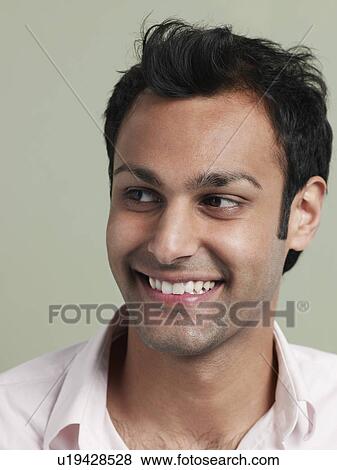 Mid adult man looking away and smiling close-up View Large Photo Image Stock Photo - Mid adult man looking away and smiling close-up. Fotosearch