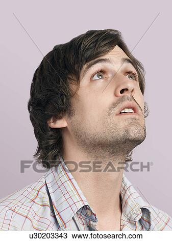 Mid adult man looking up close-up View Large Photo Image Stock Image - Mid adult man looking up close-up. Fotosearch