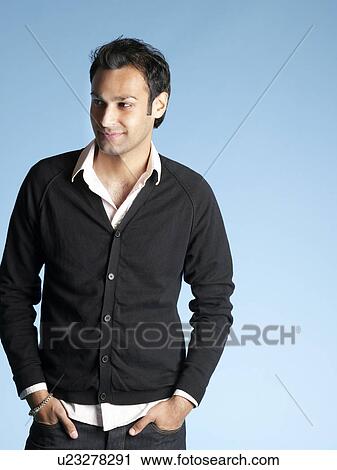Mid adult man on blue background looking to side and smiling View Large Photo Image Stock Image - Mid adult man on blue background looking to side and smiling. Fotosearch
