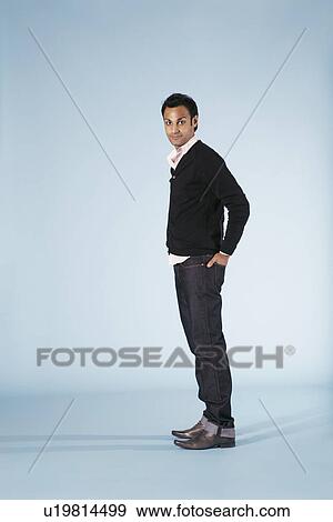 Stock Photo - Mid-adult man on blue background. Fotosearch