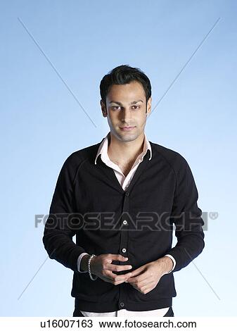 Mid adult man on blue background waist up View Large Photo Image Stock Image - Mid adult man on blue background waist up. Fotosearch
