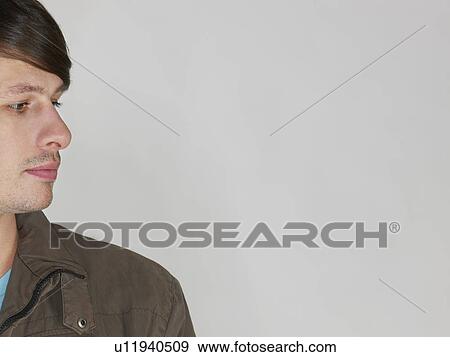 Stock Photo - Mid adult man side view close-up (cropped). Fotosearch