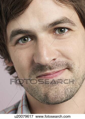Stock Photo - Mid adult man smiling close-up of face. Fotosearch