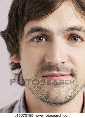 Stock Photography - Mid adult man smiling close-up of face. Fotosearch