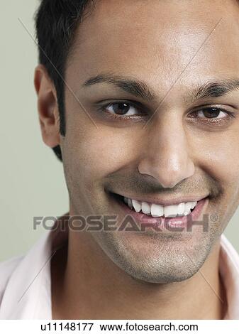 Stock Photo - Mid adult man smiling close-up. Fotosearch