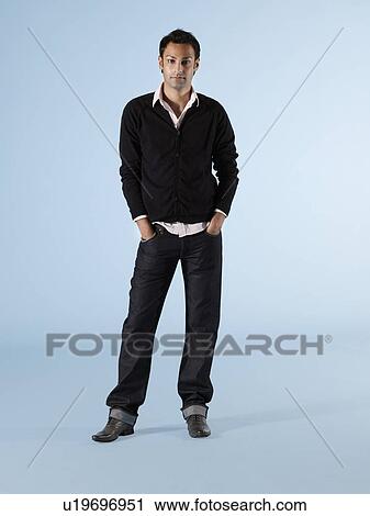 Mid adult man standing with hands in pockets View Large Photo Image Stock Image - Mid adult man standing with hands in pockets. Fotosearch