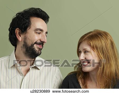 Mid adult woman and man looking in eyes and smiling View Large Photo Image Stock Photo - Mid adult woman and man looking in eyes and smiling. Fotosearch