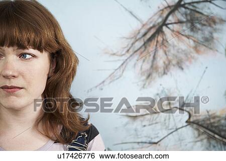 Stock Photograph - Mid adult woman in front of painting close-up (cropped). Fotosearch