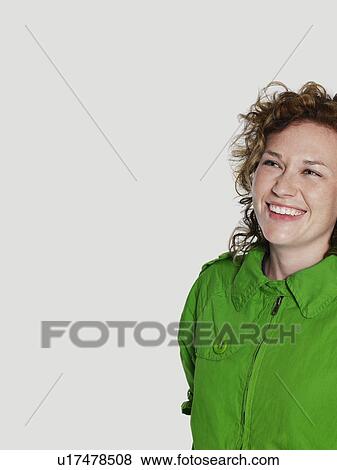 Mid adult woman in green jacket smiling View Large Photo Image Stock Photo - Mid adult woman in green jacket smiling. Fotosearch