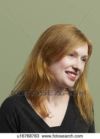 Stock Image - Mid adult woman looking away and smiling. Fotosearch