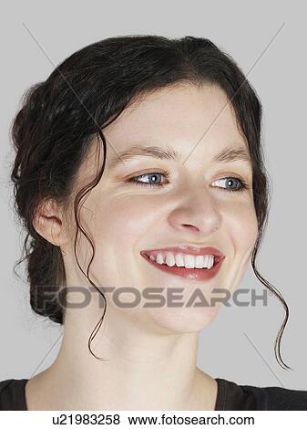 Mid adult woman looking away and smiling close-up View Large Photo Image Stock Photo - Mid adult woman looking away and smiling close-up. Fotosearch