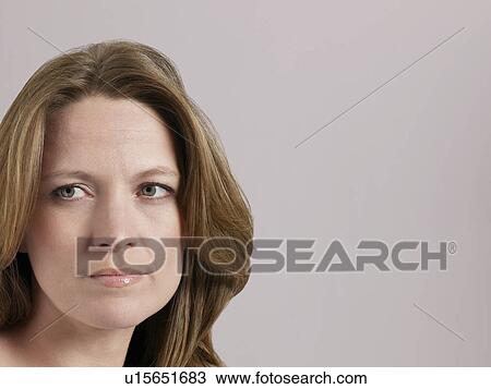 Mid-adult woman looking away close-up View Large Photo Image Stock Image - Mid-adult woman looking away close-up. Fotosearch