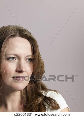 Stock Image - Mid-adult woman looking away close-up. Fotosearch