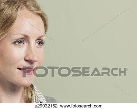Mid adult woman looking away close-up View Large Photo Image Stock Image - Mid adult woman looking away close-up. Fotosearch