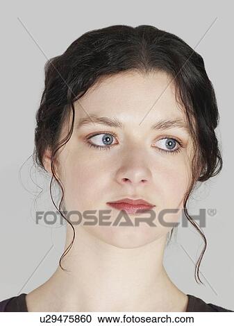 Stock Image - Mid adult woman looking away close-up. Fotosearch