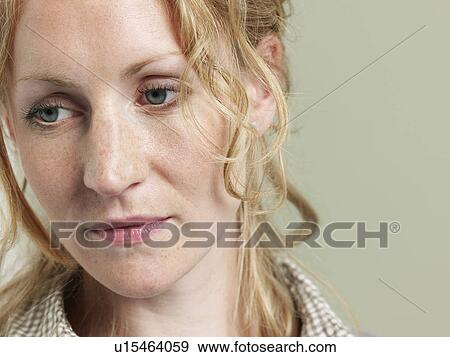 Mid adult woman looking away close-up View Large Photo Image Stock Photo - Mid adult woman looking away close-up. Fotosearch