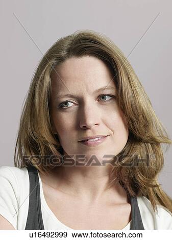 Mid-adult woman looking away close-up View Large Photo Image Stock Photo - Mid-adult woman looking away close-up. Fotosearch