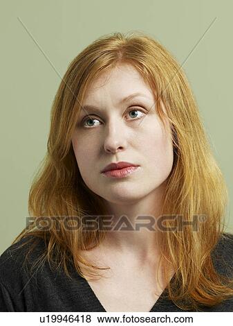 Stock Photo - Mid adult woman looking away close-up. Fotosearch