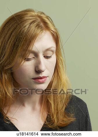 Picture - Mid adult woman looking down close-up. Fotosearch