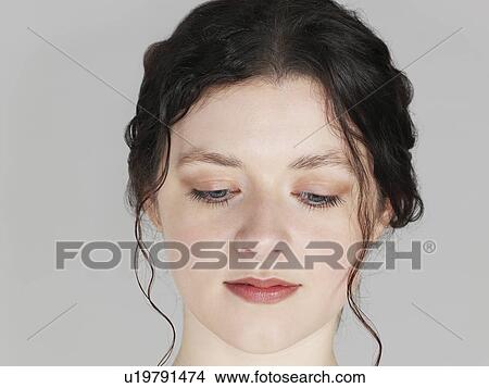 Picture - Mid adult woman looking down close-up. Fotosearch