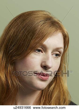 Mid adult woman looking down close-up View Large Photo Image Stock Photograph - Mid adult woman looking down close-up. Fotosearch
