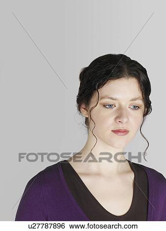 Stock Photograph - Mid adult woman looking down. Fotosearch